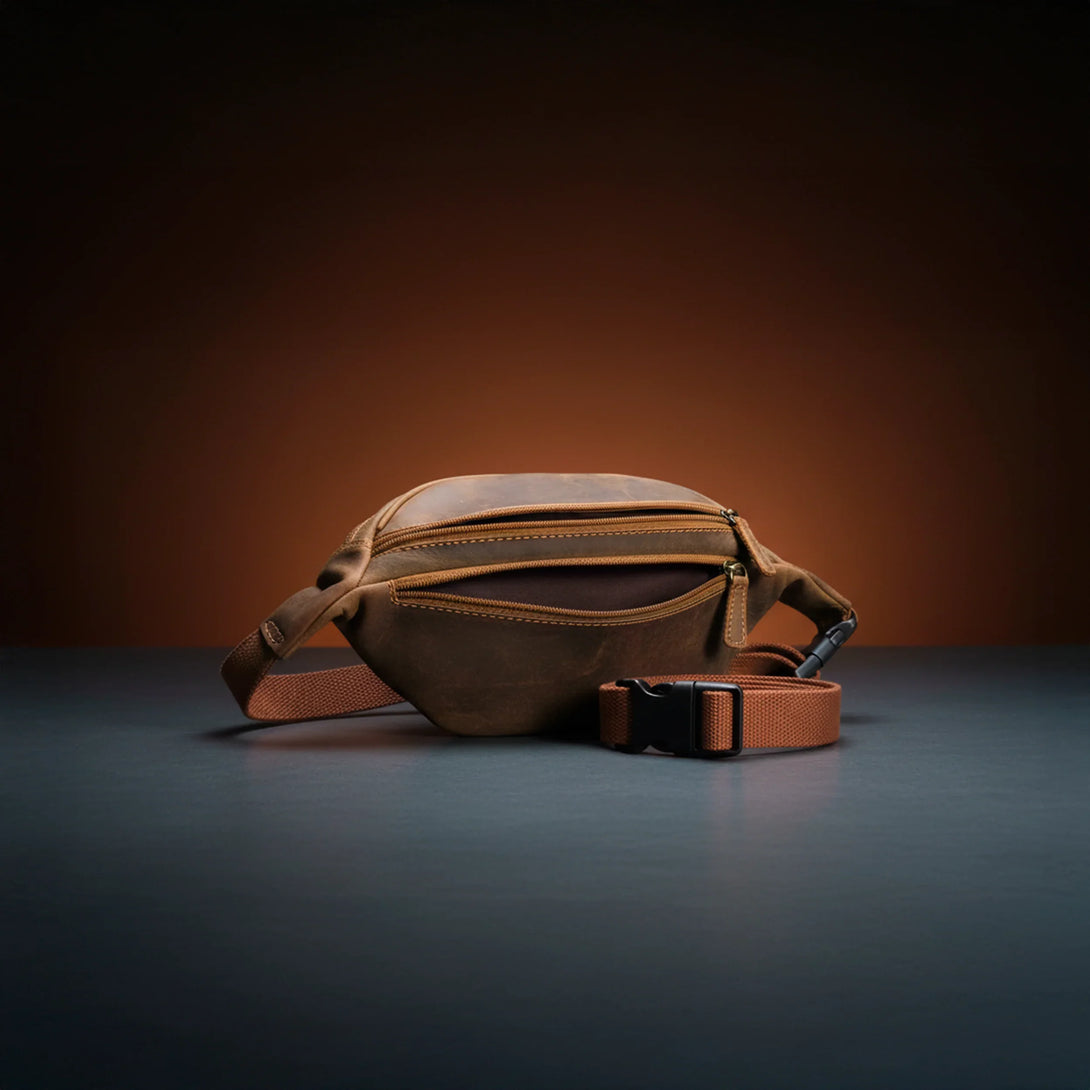 brown leather personalized wallet and belt set for men on dark surface with warm background